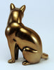 Content looking cat in a light brassy finish