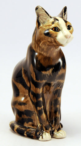 Porcelain cat, sitting proudly upright