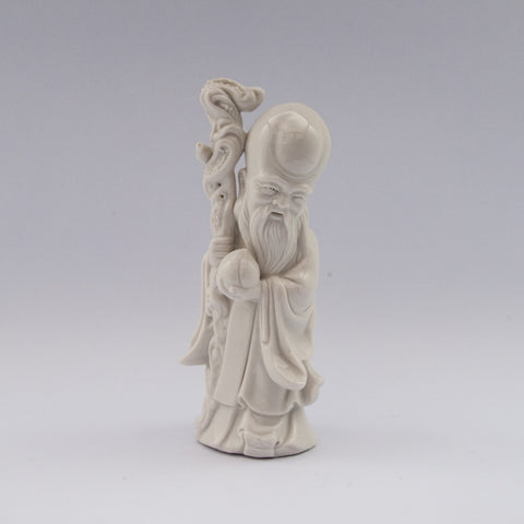 white porcelain figurine blanc de chine wiseman staff peach