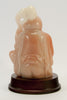 carved pink soapstone wiseman sitting holding peach staff