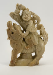 carved soapstone man sitting on dragon 010