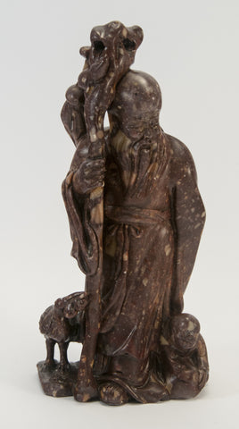 carved soapstone wiseman holding staff stork boy 050