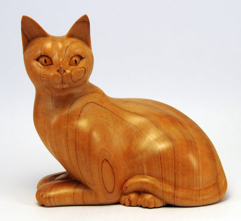 Carved wood cat, alert and noticed something