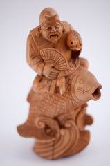 carved wood fisherman riding and holding fish 10