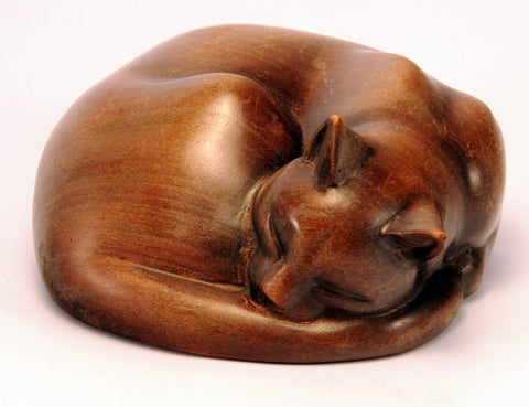 Carved wood cat, curled up sleeping