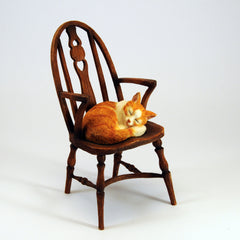 leonardo cat asleep on a chair 1