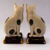 pair cats sitting gold pillow
