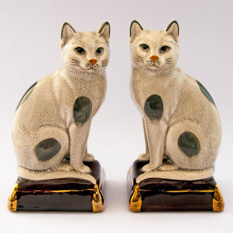 pair cats sitting gold pillow